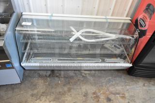 Brand new Avantco metal countertop display case with scratch and dent damage. Missing side panels visible.