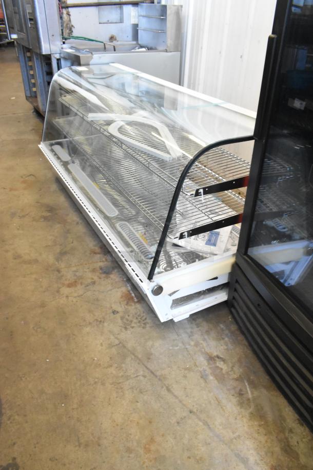 Brand new Avantco metal countertop display case, missing side panels, scratch and dent condition, clear glass front.