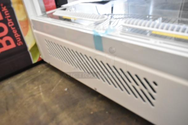 Brand new Avantco metal countertop display case; features missing side panels. Tags show venting detail. Scratch and dent condition.