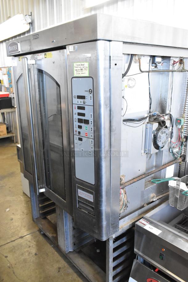 Baxter stainless steel mini rotating rack oven, natural gas powered, on double pan rack with commercial casters; control panel visible.