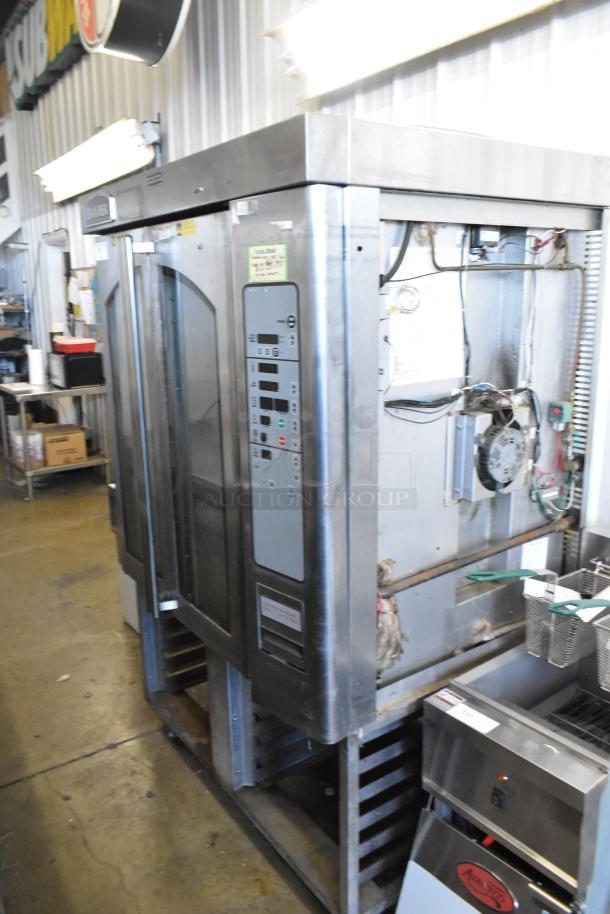 Baxter stainless steel mini rotating rack oven, natural gas, on double pan rack with commercial casters. Visible control panel.
