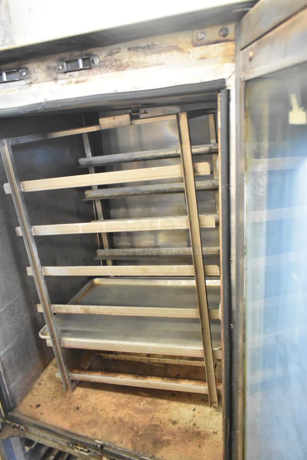 Baxter stainless steel commercial mini rotating rack oven, natural gas powered, on double pan rack with commercial casters.