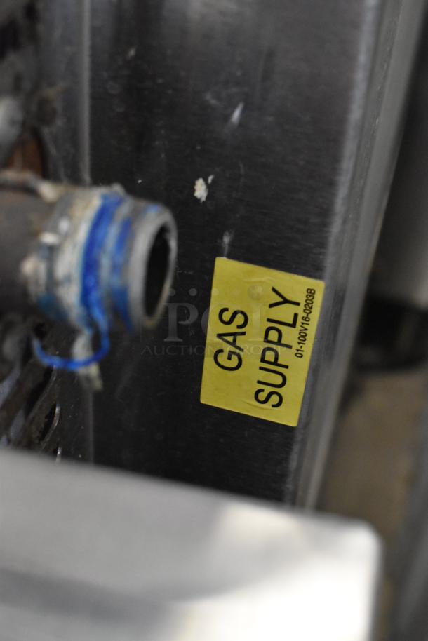 Baxter stainless steel mini rotating rack oven, commercial-grade on double pan rack with casters. Gas supply label visible.