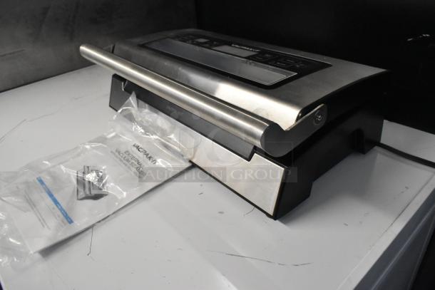 VacPak-It 186VSM12PRO vacuum sealer with 12" seal bar, cutter, and roll holder, new condition, marked "Caution Hot."
