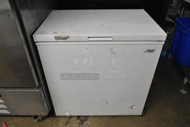 Arctic King ARC070S0ARWW metal chest freezer, hinge lid, 115 volts, 1 phase. Visible wear on top, model label on front.