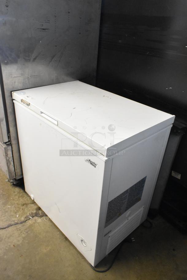 Arctic King ARC070S0ARWW metal chest freezer, hinge lid, visible wear, 115 volts, 1 phase, labels on front panel.