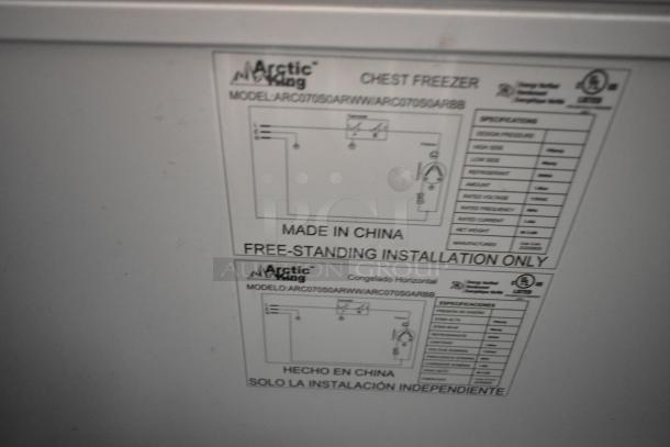 Arctic King ARC070S0ARWW chest freezer, metal, hinge lid, 115V, 1 Phase. Label shows model, specs, and installation info.