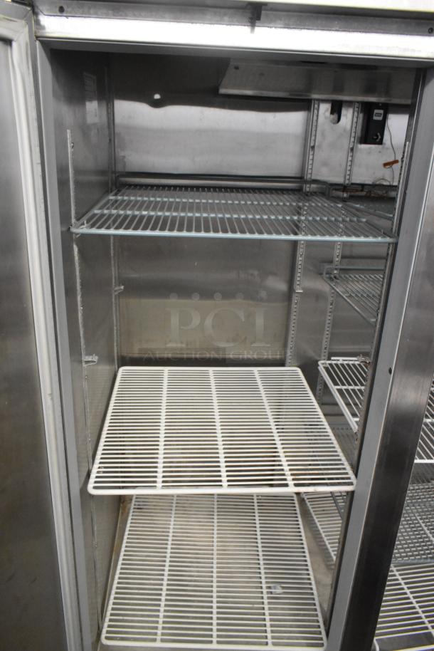 Beverage Air HBF49-1 stainless steel commercial two-door reach-in freezer with poly coated racks, on commercial casters.