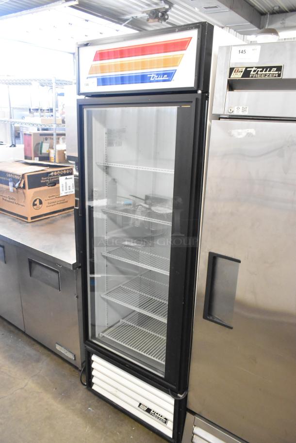 True GDM-23F commercial freezer with single glass door, poly-coated racks, and colorful top panel. 115V, in good condition.