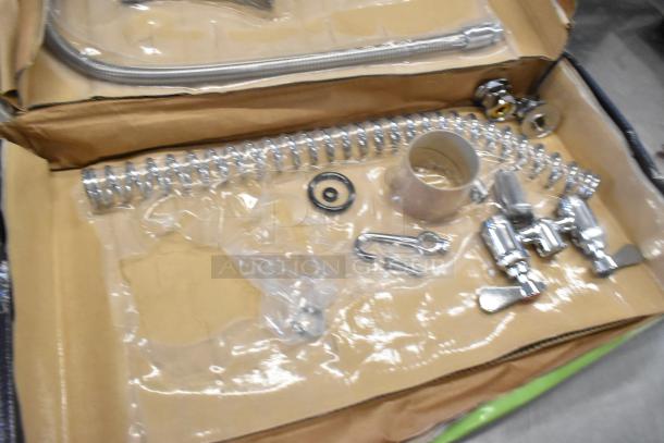 Brand new Regency 600PRD4X pre-rinse faucet with 1.15 GPM, deck-mounted, shown in packaging with visible components.
