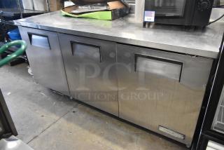 True TWT-72 stainless steel undercounter cooler with three doors, on commercial casters. 115 volts, 1 phase.