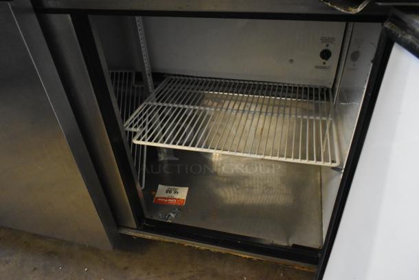 True TWT-72 stainless steel 3-door undercounter cooler with commercial casters. Features shelves, 115V, 1 phase.