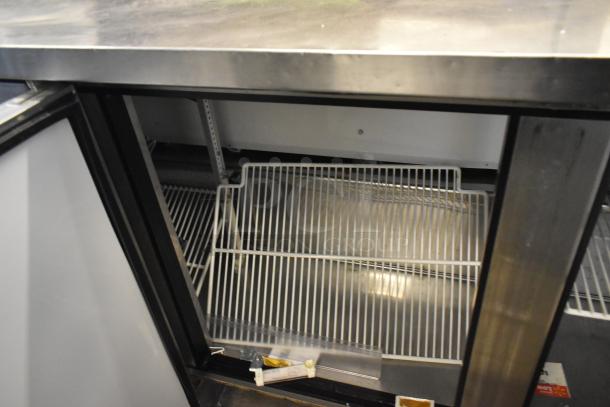 True TWT-72 stainless steel undercounter cooler with three doors, commercial casters, 115 volts, 1 phase. Clean interior.