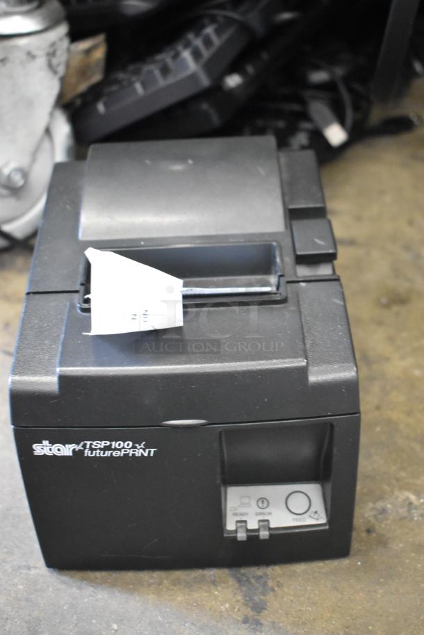Star TSP100 futurePRNT receipt printer, black, with visible On/Off and Feed buttons. Condition shows light wear.