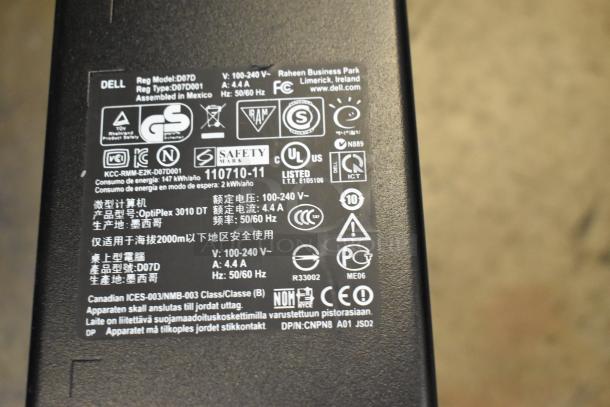 Label on a Dell computer tower showing model OptiPlex 3010 DT with power specifications and certifications.