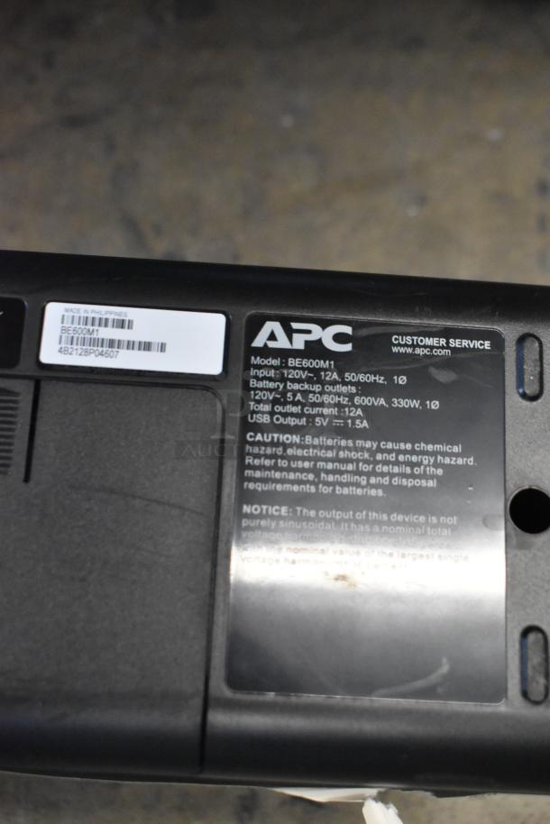 Lot of Star TSP100 printer, 4 keyboards, computer tower, APC BE600M1 UPS. APC label specifies model and output details.