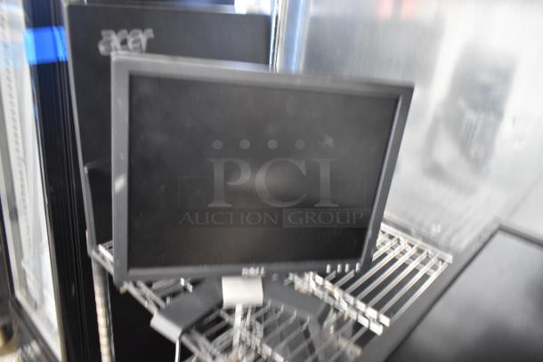 4 computer monitors including Lenovo, Dell, and Acer models on a metal shelf. Buyer must pick up. Not shippable.