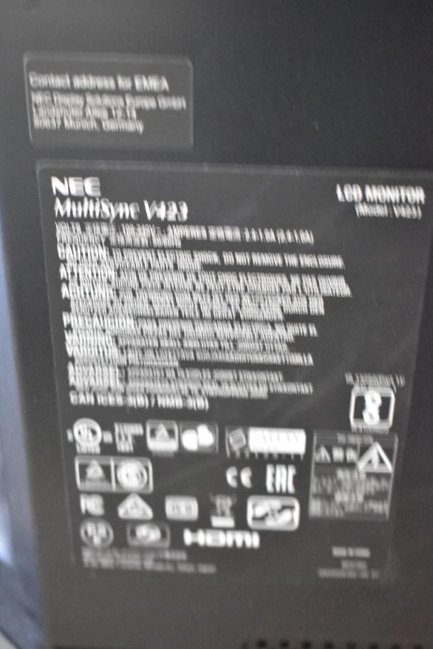Labels on the back of a NEC MultiSync V423 LCD monitor, showing model and specifications.