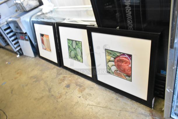 Three framed pictures featuring salad ingredients: cheese, cucumbers, and tomato slices. Black frames, good condition.