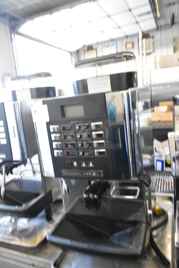 Faema stainless steel commercial automatic espresso machine with steam wand, featuring a control panel and drip tray.