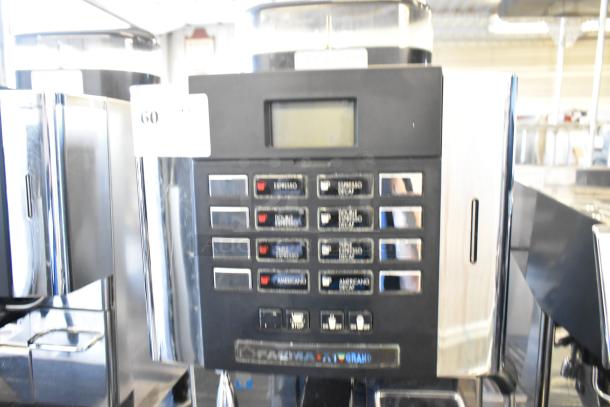 Faema stainless steel commercial automatic espresso machine with steam wand, digital controls, in good condition.