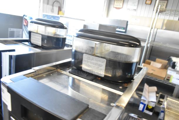Faema stainless steel commercial espresso machine with automatic features and steam wand, in used condition.