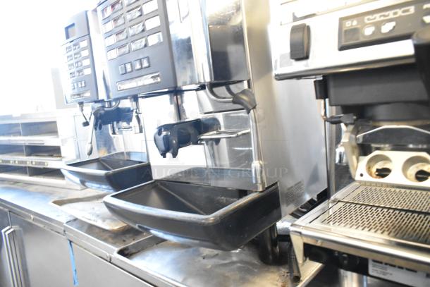 Faema stainless steel commercial espresso machine with steam wand and automatic controls, in good condition.