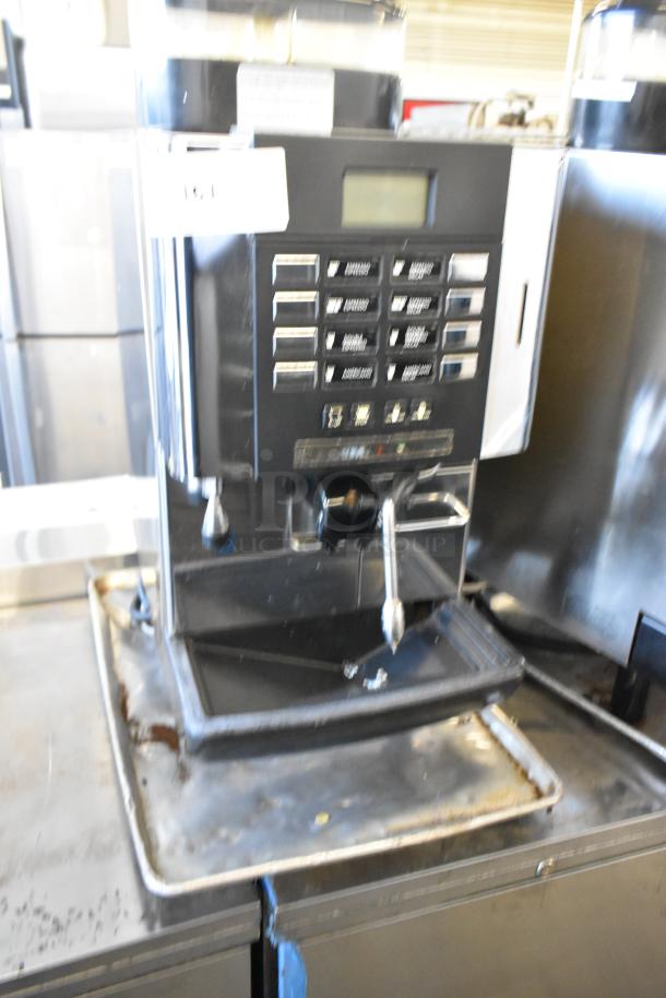 Faema stainless steel commercial countertop automatic espresso machine with steam wand, buttons visible, used condition.