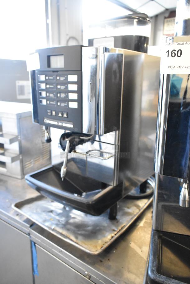 Faema stainless steel commercial automatic espresso machine with steam wand, countertop model, in working condition, visible control panel.