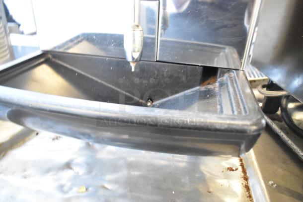 Faema stainless steel commercial espresso machine with steam wand, visible drip tray, slight wear, ideal for cafes.
