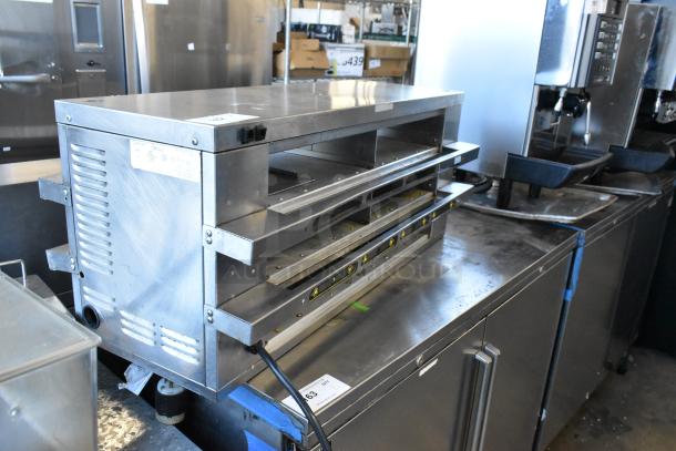 Merco MHCFA34 stainless steel countertop holding bin, 208V, 1 Phase, in used condition, showing control dials and open slots.
