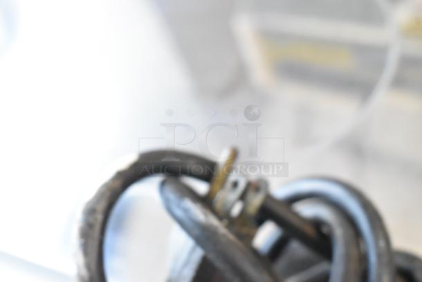 Blurry close-up of a Bunn coffee bean grinder component. Unable to discern key features or condition.