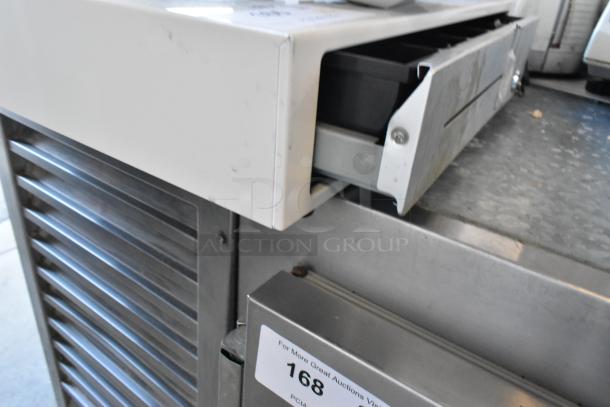 Clover POS cash drawer with slight wear, open to show compartments. Model tag visible. Includes monitor and receipt printer.