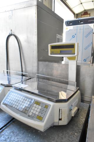 Easy Weigh LS-100 metal countertop scale, 240V, 1 phase. Features digital display, keypad. Used condition with light wear.