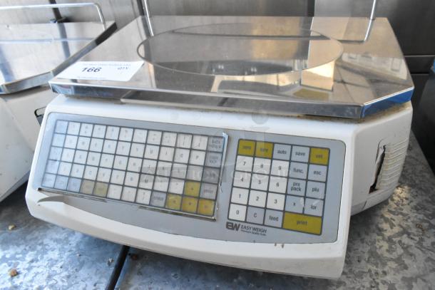 Easy Weigh LS-100 metal countertop scale, featuring a digital keypad and display. 240 volts, 1 phase. Shows light wear.
