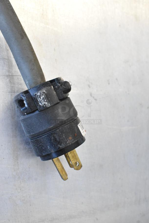 Black power plug for Metro C199 holding cabinet, showing visible wear and scratches. Used in commercial setups, 125V, 1 phase.