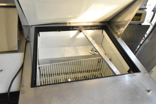 True TSSU-27-12M-B Stainless Steel Prep Table, open lid, interior view, commercial casters, 115V, used condition.