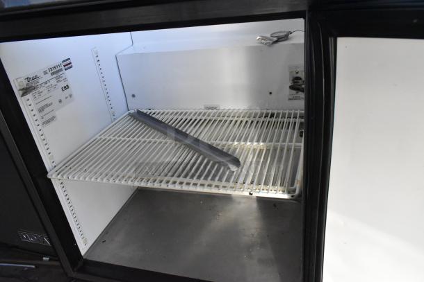 True TSSU-27-12M-B commercial sandwich salad prep table interior. Visible model label, empty shelf. 115V, 1 Phase.