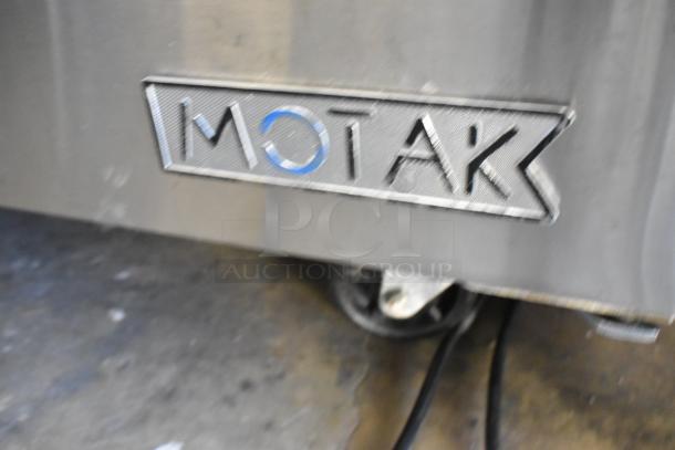 Motak MST-48-X stainless steel prep table, shown with logo. Features mega top, bain marie design, on commercial casters.