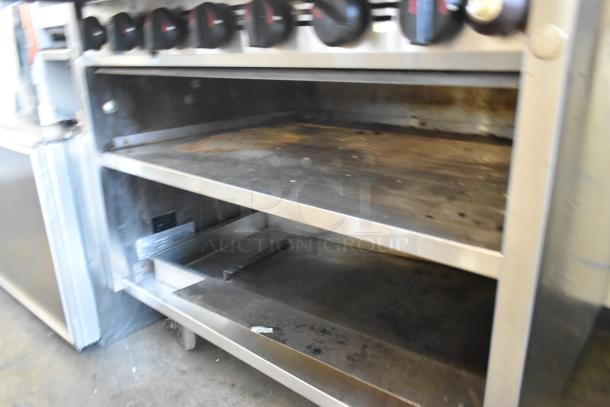 MagiKitch'n 636 stainless steel natural gas charbroiler grill with under shelf, used condition, featuring control knobs.