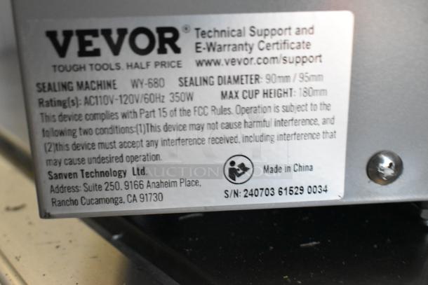 Vevor WY-680 stainless steel bubble tea cup sealing machine label, 120 volts, model details, and compliance information visible.