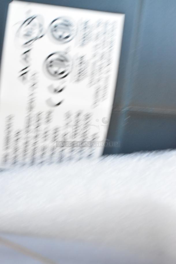 Blurred close-up of a label on an AvaMix 928IBHD18 18" Heavy-Duty Immersion Blender, indicating model and specs.