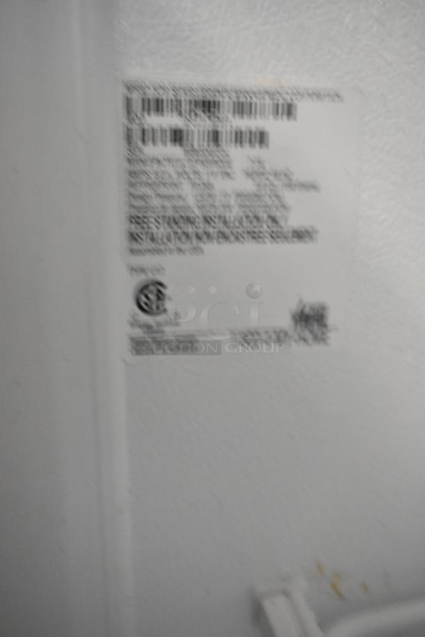 Kenmore metal single door reach-in freezer, 115 volts, 1 phase. Features label with specifications.