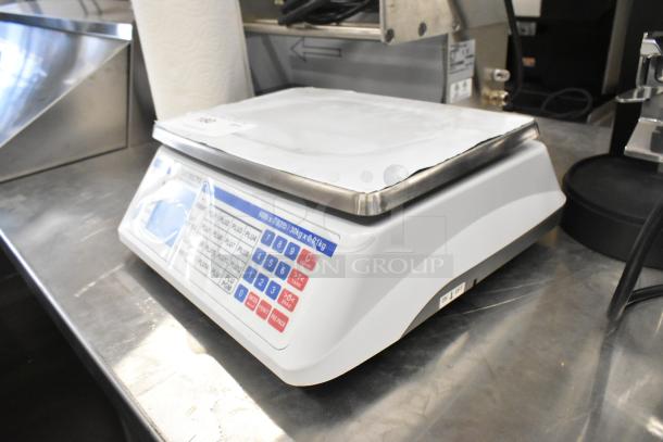 Detecto D60 countertop scale with digital keypad. Slight signs of use. Stainless steel weighing platform.