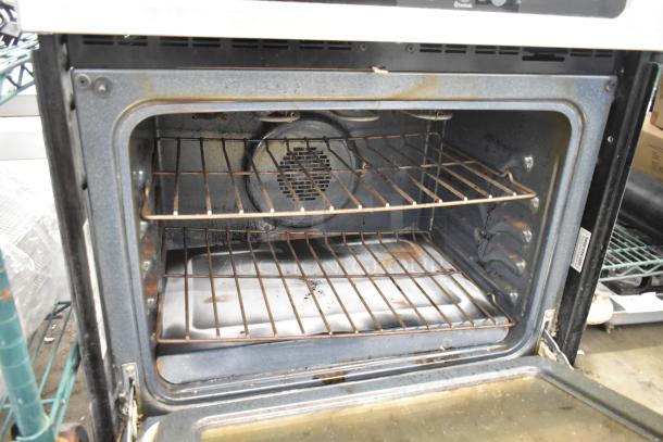 Frigidaire PLEB30S90CB stainless steel electric oven, visible wear, dual racks, voltage label shows 120/208-240V.