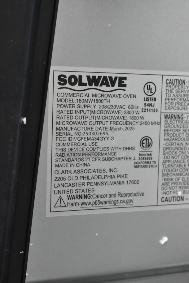 Solwave 180MW1800TH stainless steel commercial microwave oven label. Model details, voltage, and compliance info visible. Brand new, has scratches and dents.