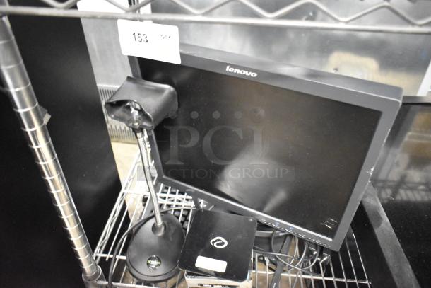 Lenovo monitor with Cloudcover G9CX, Intel NUC6i3SYK, and barcode stand on wire shelf.