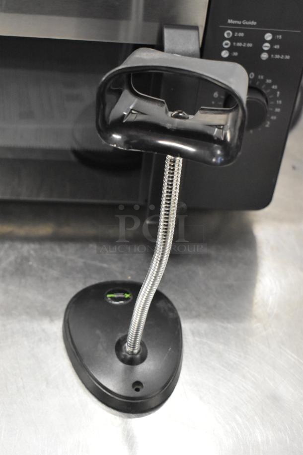 Barcode stand with flexible neck attached to Lenovo monitor setup, featuring Cloudcover G9CX and Intel NUC6i3SYK.