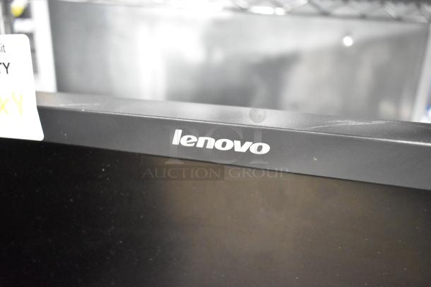 Lenovo computer monitor with Cloudcover G9CX, Intel NUC6i3SYK, and barcode stand. Visible logo, slight surface wear.