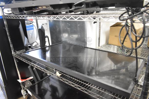 Three computer monitors on shelves: Lenovo, Dell, and Acer. Monitors appear used, display screens visible. Buyer pickup required.